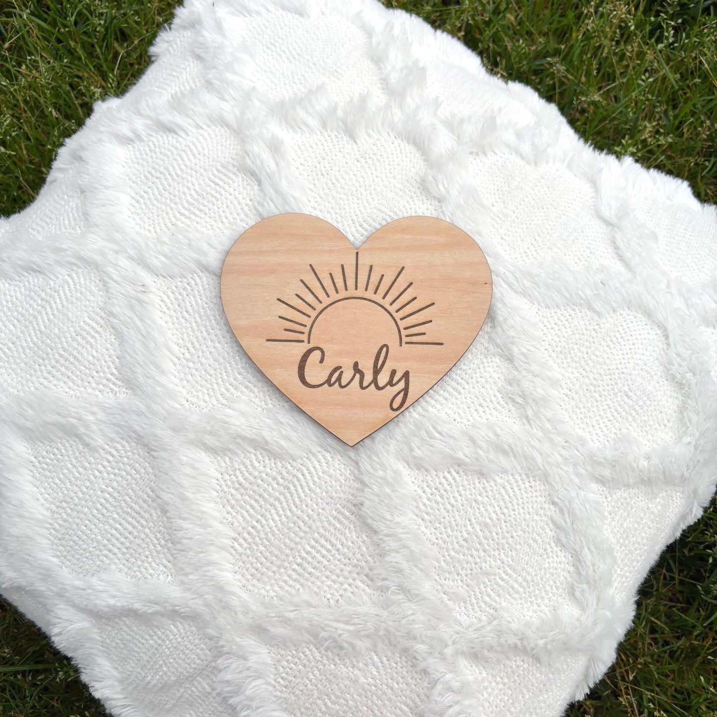 Custom heart-shaped wooden name sign with sunburst design. Perfect for nurseries, newborn gifts, or baby photo props. Personalized for you!